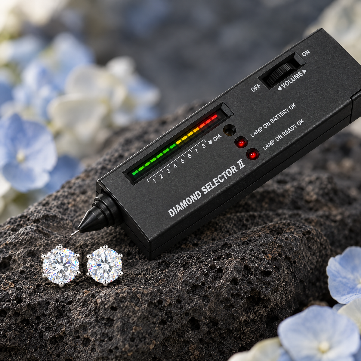 Diamond Tester Pen beside solitaire studs on volcanic rock