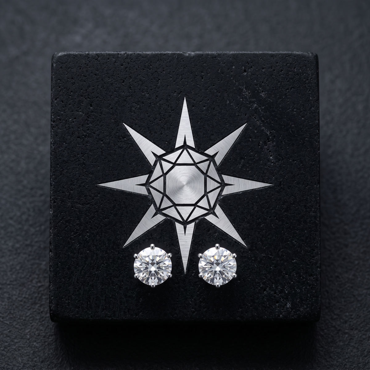 Crater star mark inlaid in silver on black stone with moissanite solitaire studs
